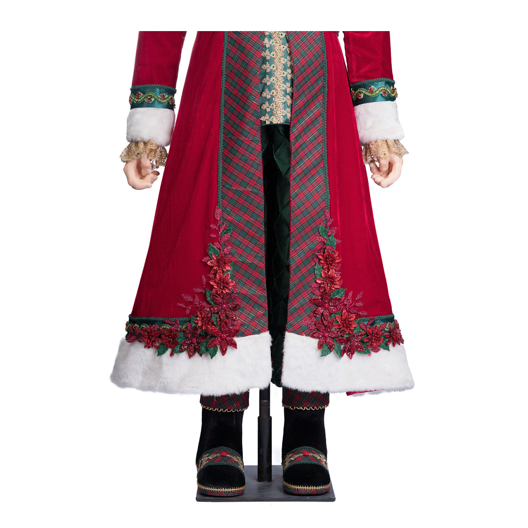 Close-up of Santa’s coat featuring poinsettia embellishments, plaid fabric, and white fur trim.