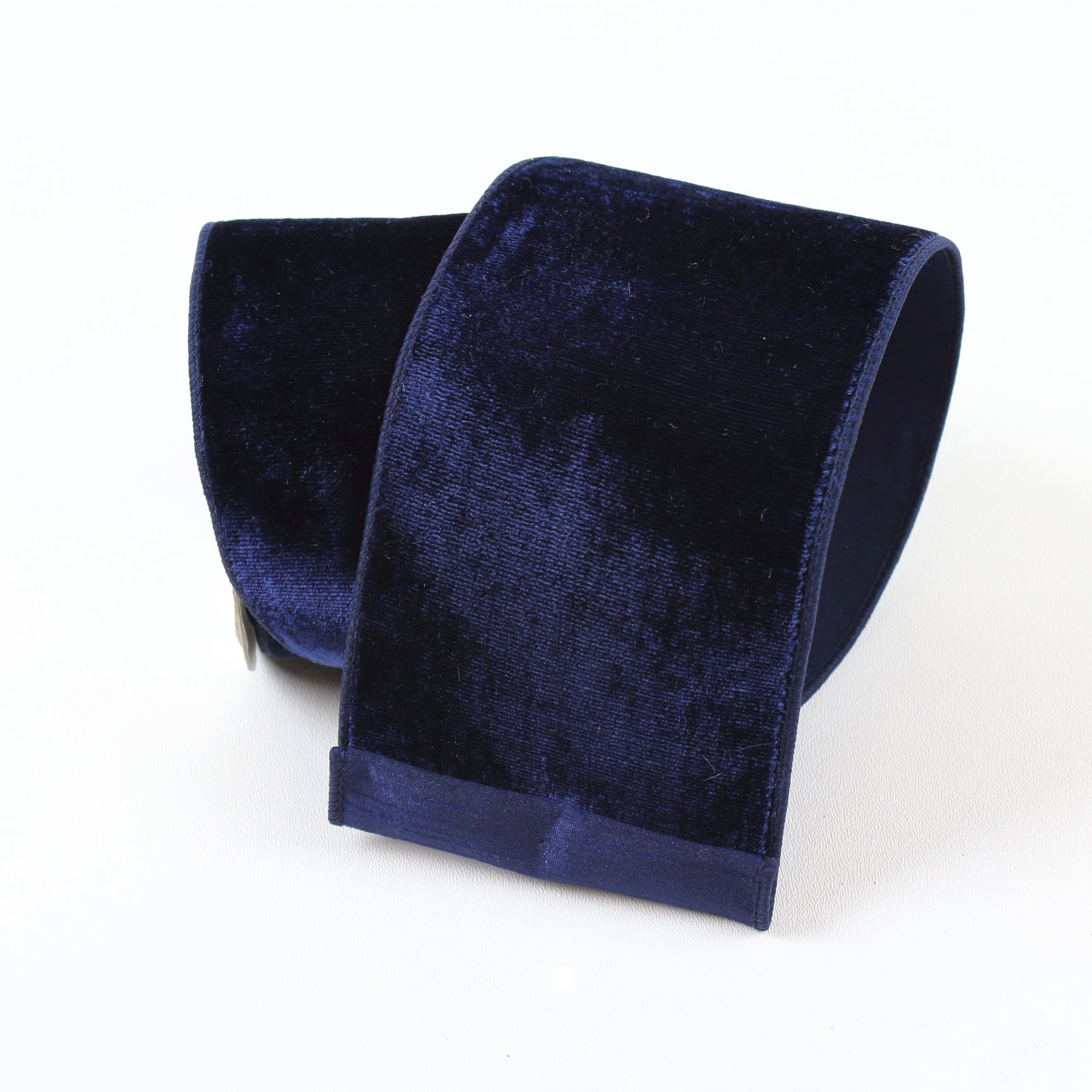 Deep navy blue velvet wired ribbon roll with a plush finish.