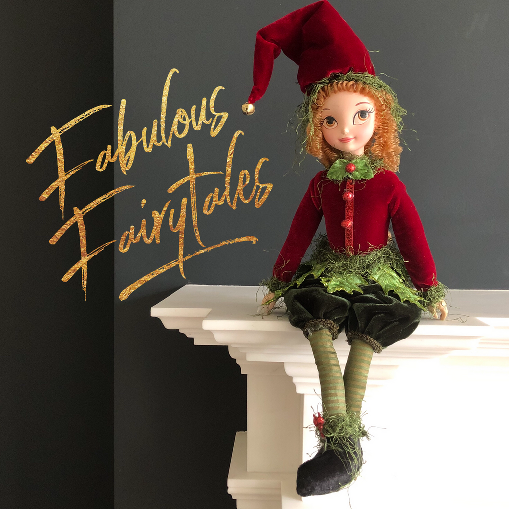 Fabulous Fairytales London luxury Christmas shop featuring a festive elf doll in red and green attire, part of our designer holiday decorations.