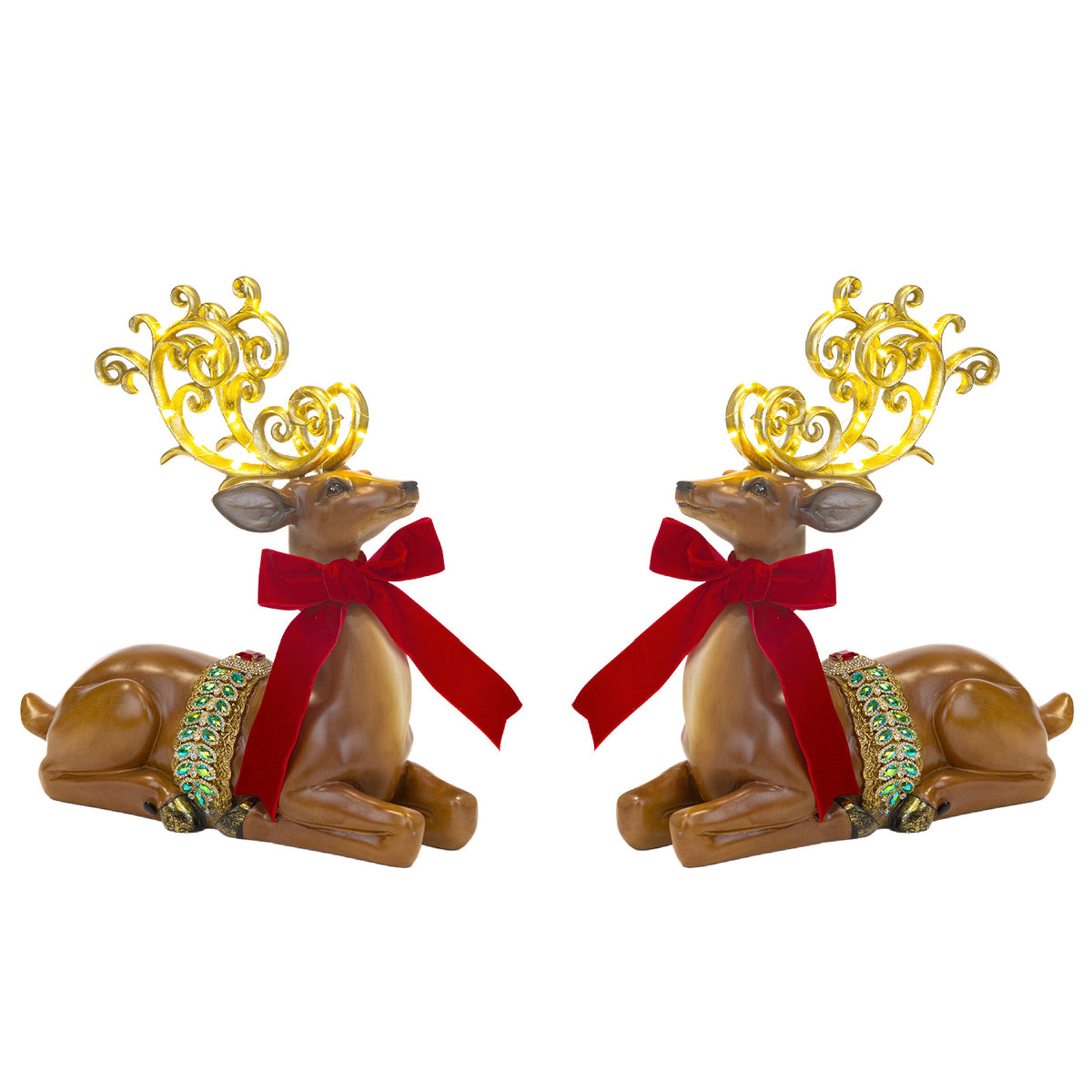 Two reindeer figurines with gold antlers and red bows on a white background