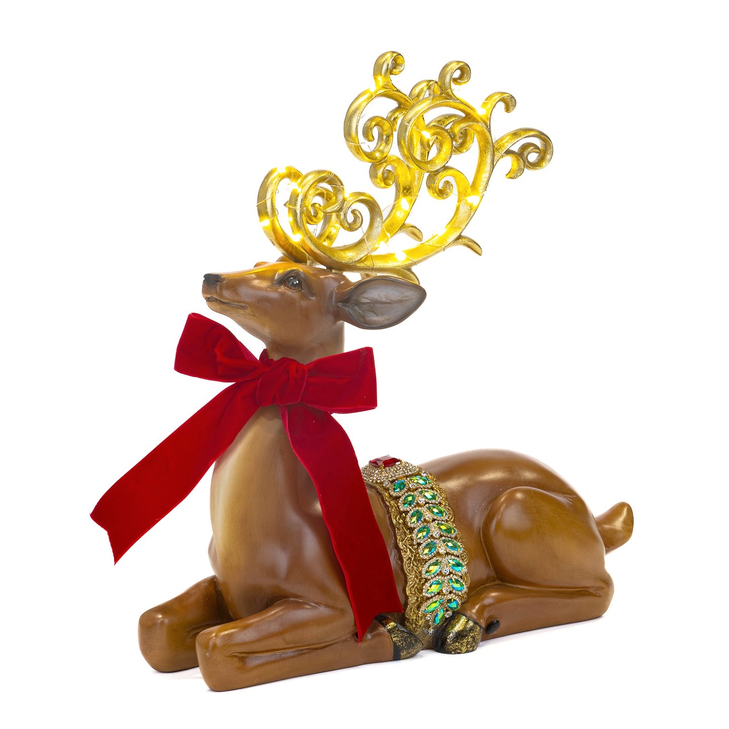 Decorative reindeer figurine with gold antlers, red bow, and green gemstone collar on a white background