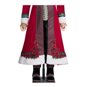 Close-up of Santa’s coat featuring poinsettia embellishments, plaid fabric, and white fur trim.