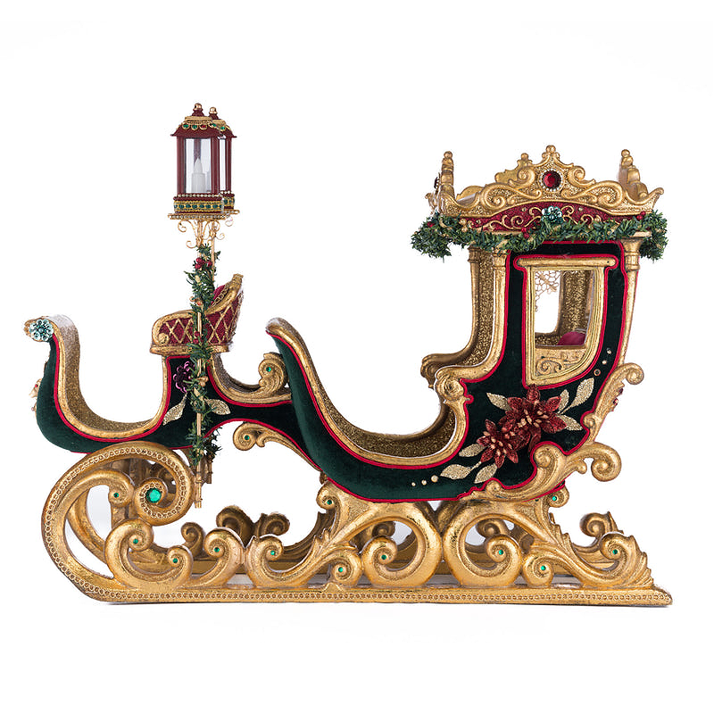 Luxurious green and berry velvet Christmas sleigh with lanterns and gold trim