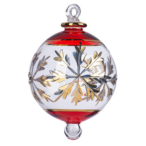 Hand-blown clear glass Christmas ornament with red rim and gold snowflake design.
