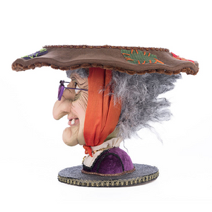 Sculpted witch head dessert stand with purple glasses and grey hair