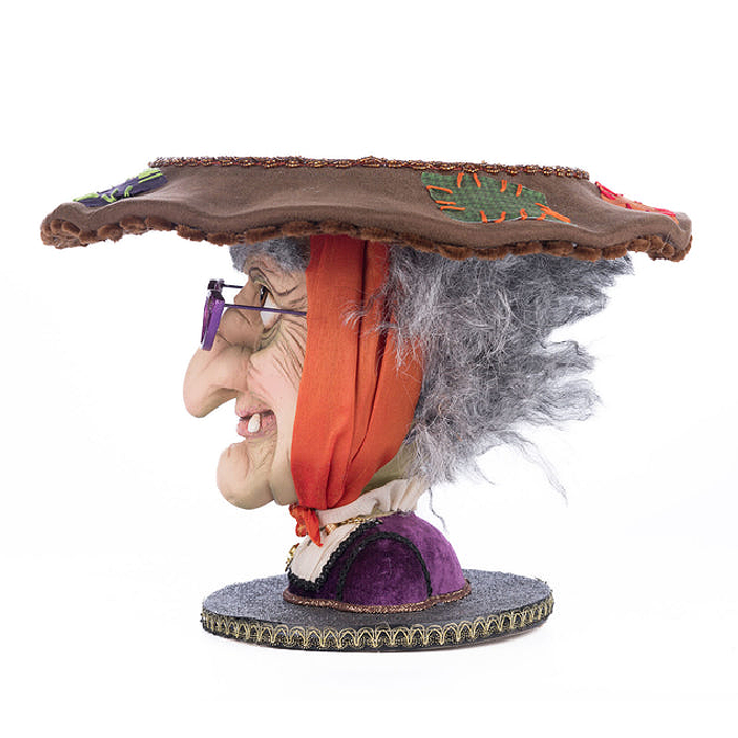 Sculpted witch head dessert stand with purple glasses and grey hair